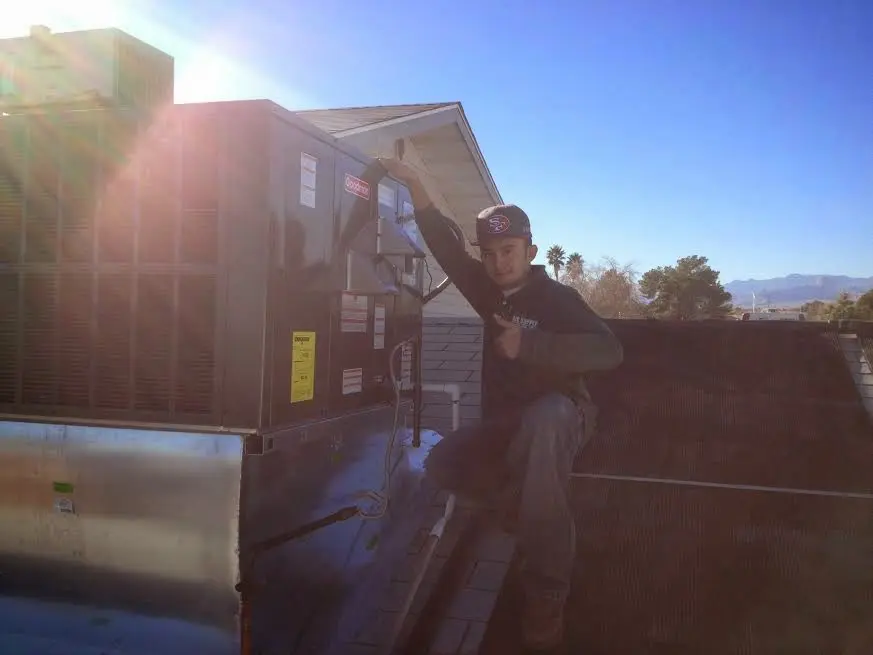 HVAC technician performing Boiler Repair on a rooftop unit in Mount Pleasant